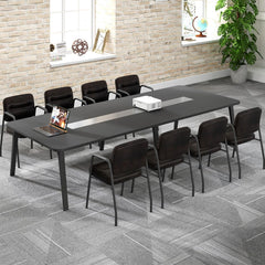 The office chairs set up around a long dark boardroom table in a spacious and bright office interior