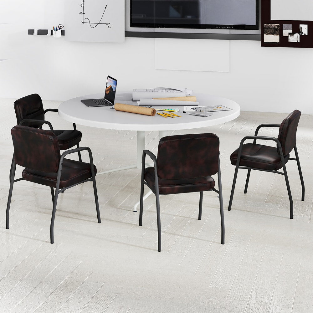 Four rustic brown waiting room chairs around a circular table in a meeting room