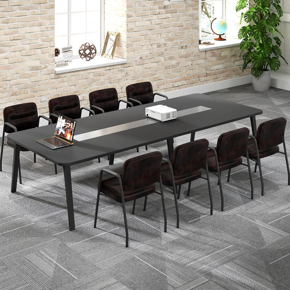 A row of eight rustic brown waiting room chairs around a long conference table