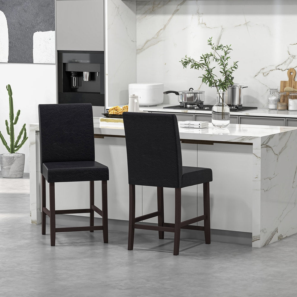 The bar stools positioned near a kitchen counter with a marble top and white cabinetry