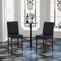 The bar stools arranged around a small round table in a room with patterned flooring