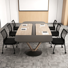 The office chairs arranged around a large wooden meeting table in a bright modern office space