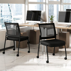 Two black guest chairs with wheels in a modern office setting