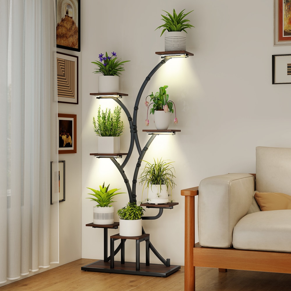 The corner plant stand with plants in a living room next to a sofa