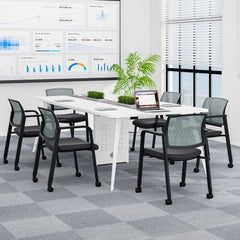 Four grey office chairs arranged around a meeting table in a modern office space