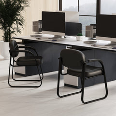 Two black office chairs with sled base in a modern office setting