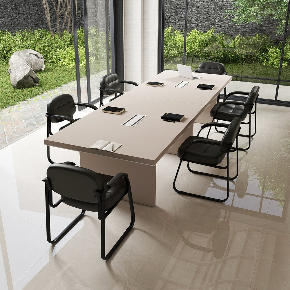 Several black office chairs arranged around a large conference table
