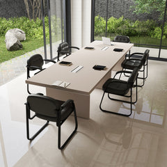 Several black office chairs arranged around a large conference table