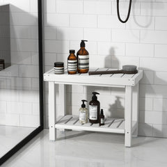 The shower stool inside a tiled shower enclosure holding various skincare products and a brush