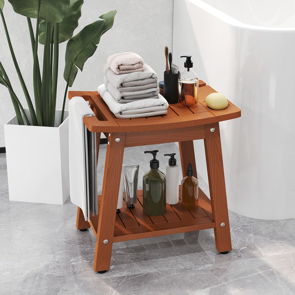 The bath safety bench holding various bottles and folded towels next to a white bathtub