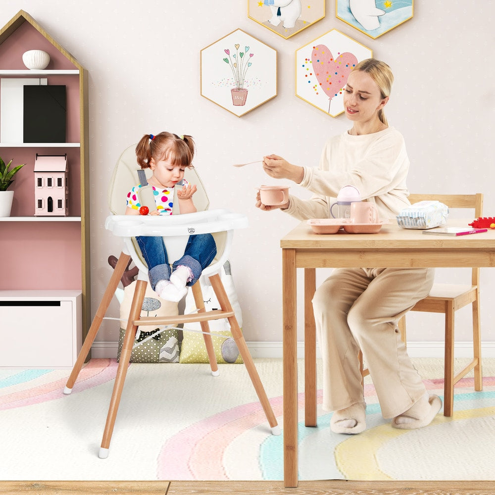 The high chair in a child's bedroom with a toddler eating while a woman feeds them