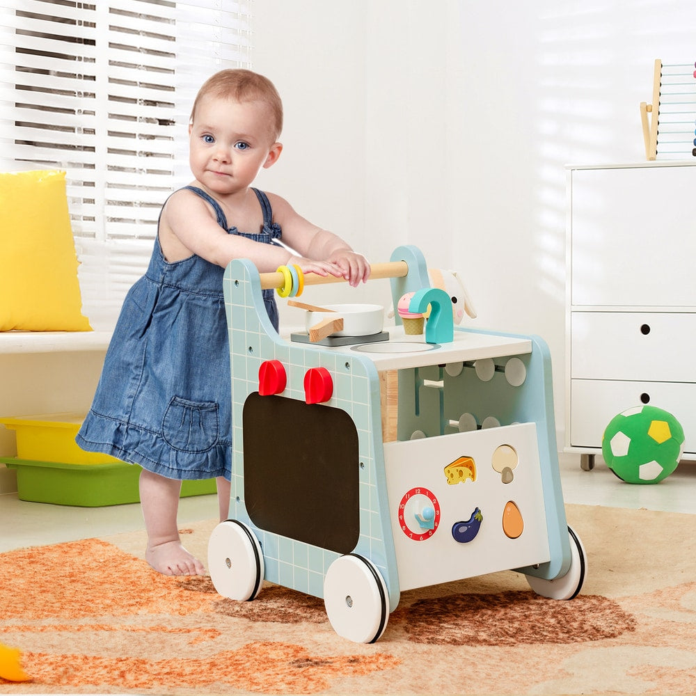 Baby girl playing with the blue wooden baby stroller push and pull learning activity center