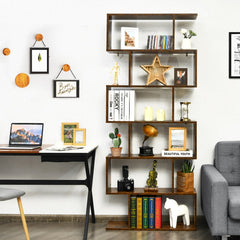 The wooden bookcase positioned next to a desk and a grey sofa in a living room