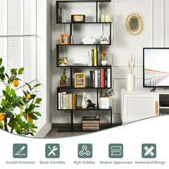 Close up of the black S-shaped bookcase showing its construction and some decorative items