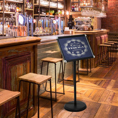 The presentation supplies stand placed on a wooden floor inside a busy bar