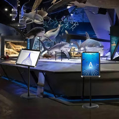 Two presentation supplies stands positioned inside a museum exhibit hall
