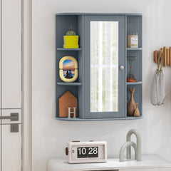 The wall cabinet displayed on a white wall with decorative items and a small clock