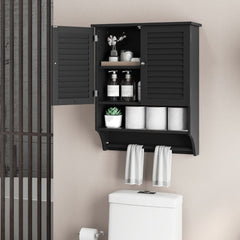The wall cabinet installed above a toilet with doors open and towels hanging below