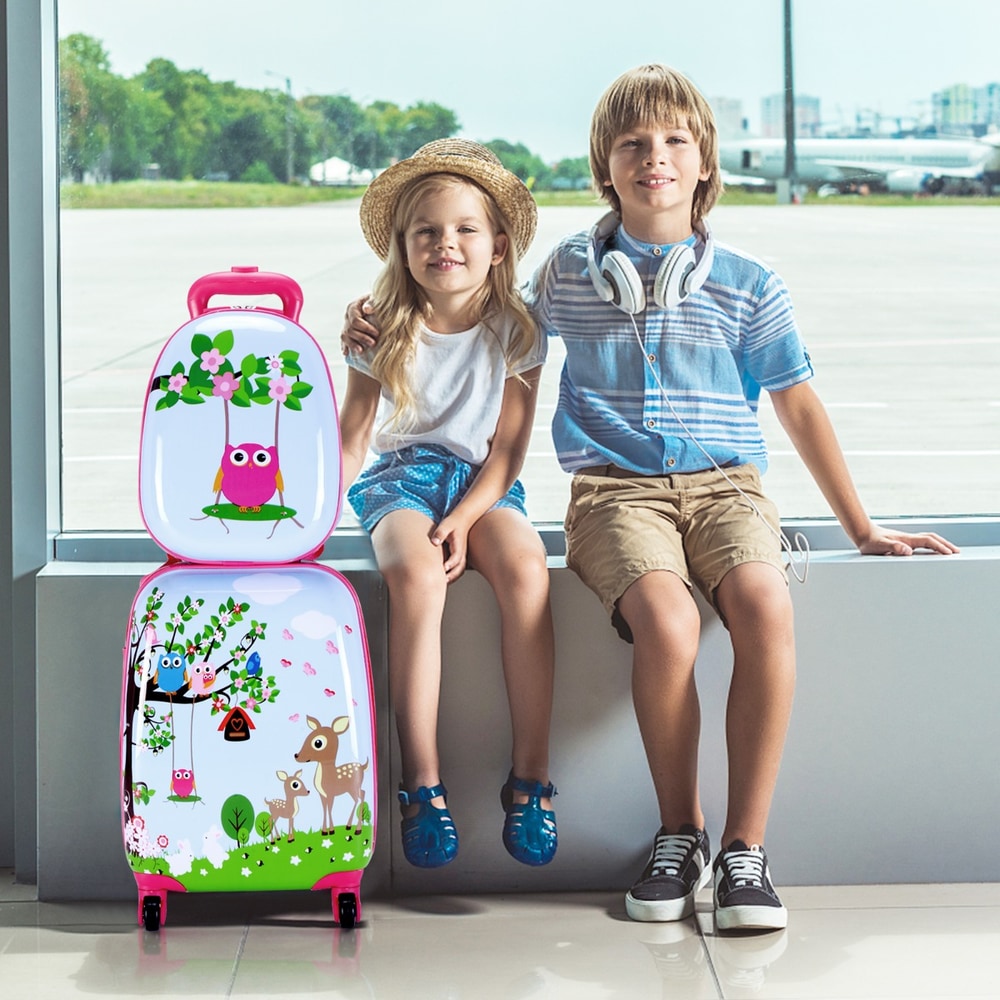Children sitting with the kids luggage set by a window