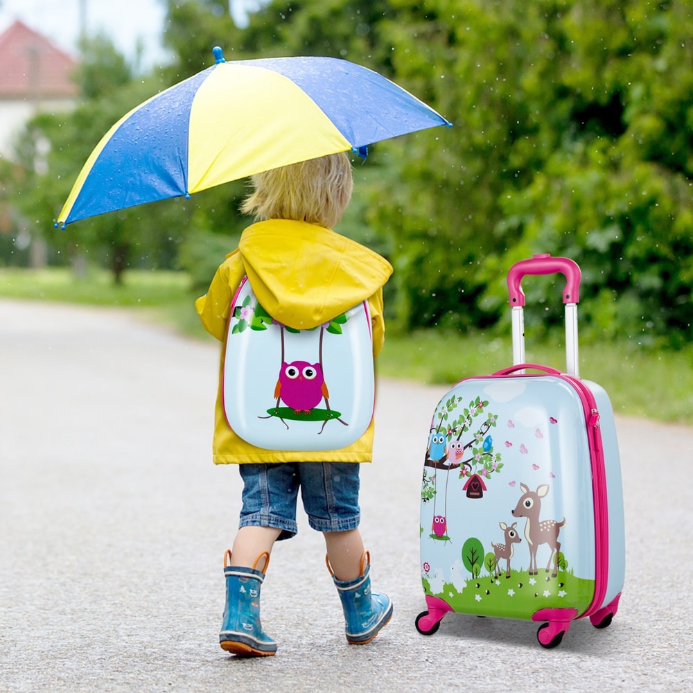 Child wearing the backpack from the kids luggage set in the rain