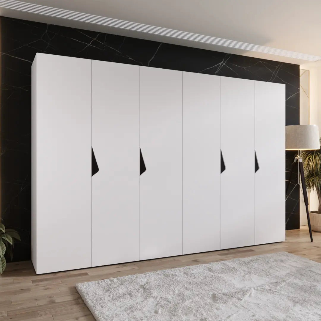 The hinged wardrobe in a white finish shown in a bedroom setting