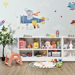Kids storage bookcase filled with toys and books in a child's playroom with wall decals