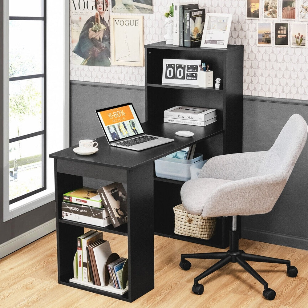 The office desk set up in a home study with a laptop and books on the shelves