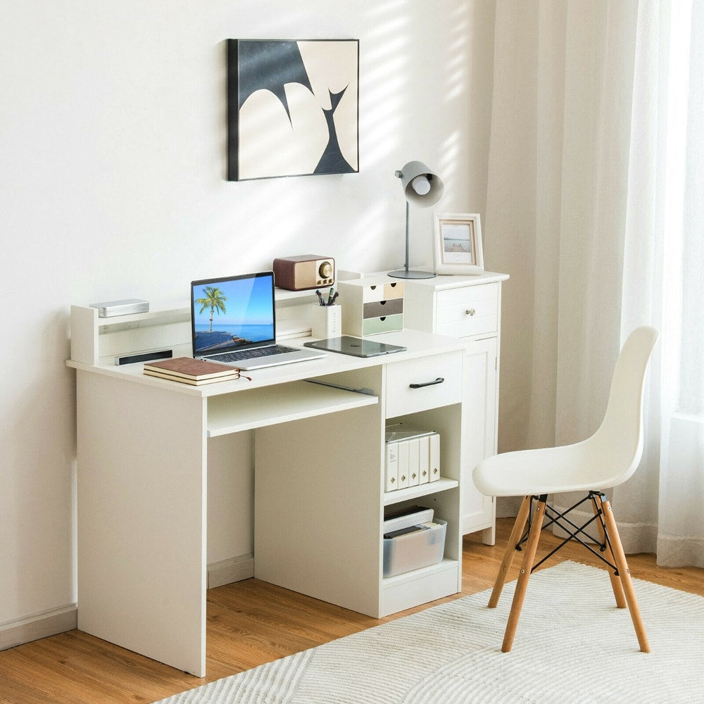 The white office desk shown in a room with a laptop and lamp on it