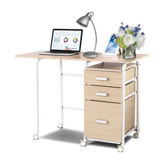 Folding Computer Desk with a laptop, lamp, and flowers on top and three drawers on the side