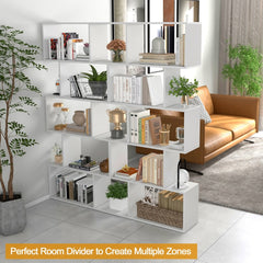 The white shelving unit used as a room divider, separating a living space