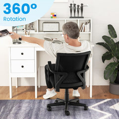 Person sitting in the black office chair at a desk to demonstrate the swivel movement