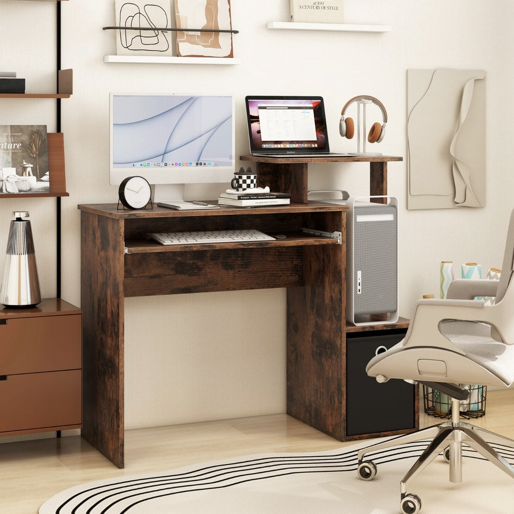 The office desk set up in a home study with a computer, laptop and office chair