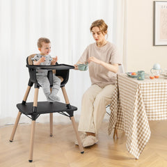 The high chair in use with a baby sitting at a dining table next to an adult