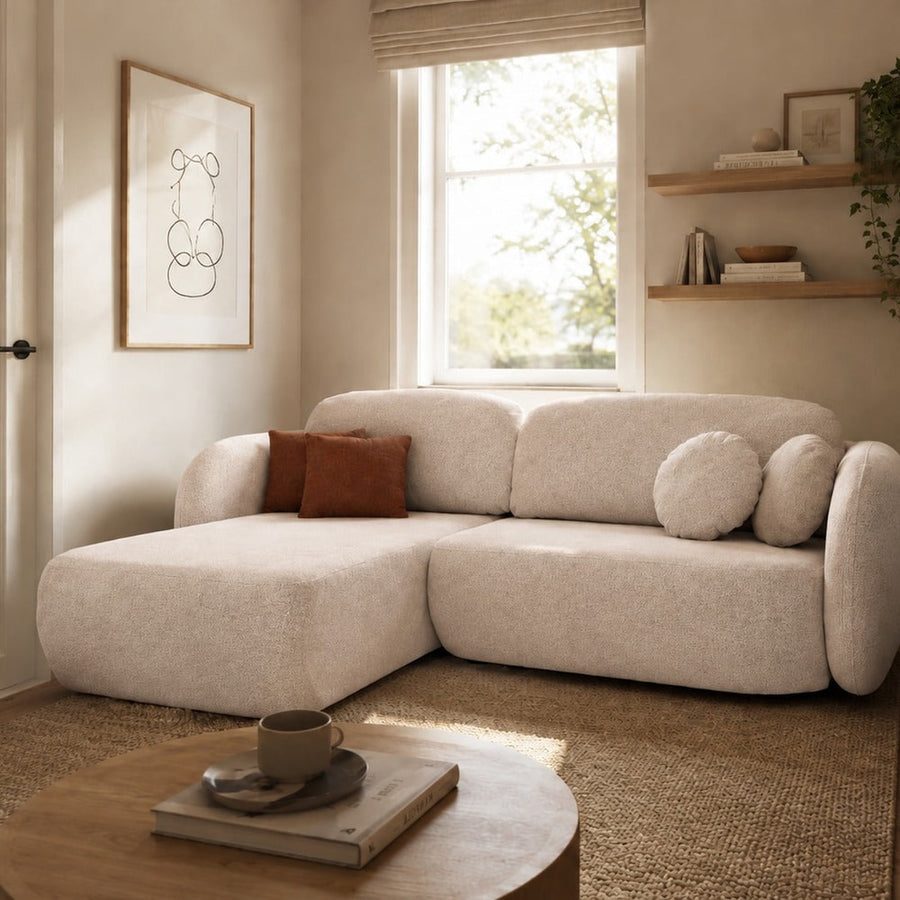 Corner Sofa Bed Olio I in cream fabric with a chaise longue section in a bright living room