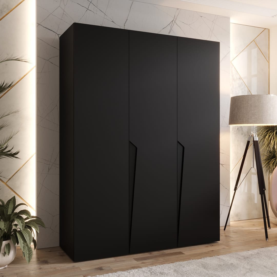 The hinged wardrobe in a sleek black finish, displayed in a contemporary room with a floor lamp