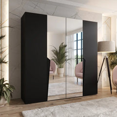 The hinged wardrobe in black with mirrored doors in a bedroom