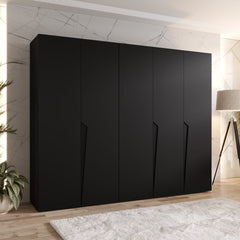 The hinged wardrobe in a matte black finish placed in a contemporary bedroom interior