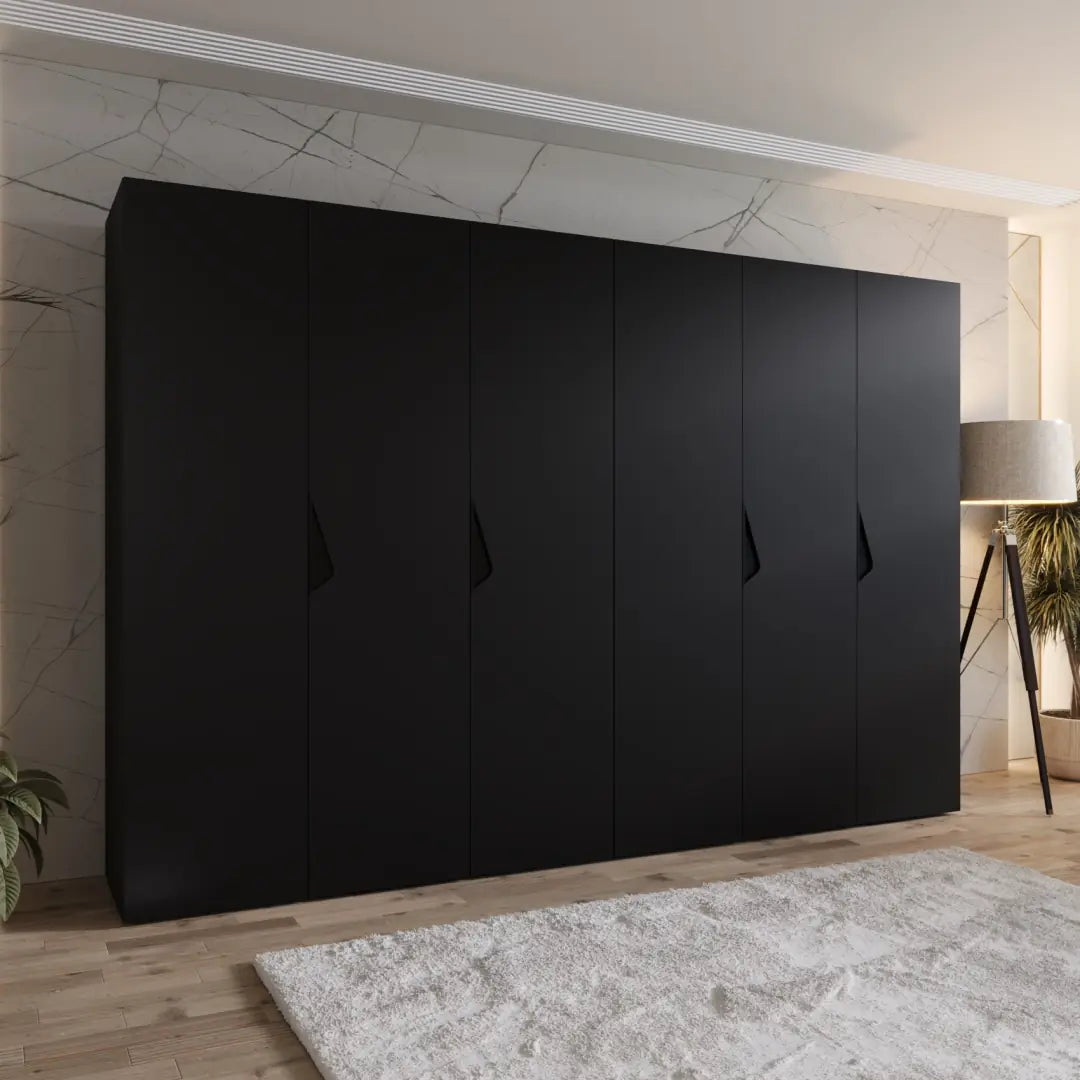 The hinged wardrobe in a black finish shown in a bedroom setting