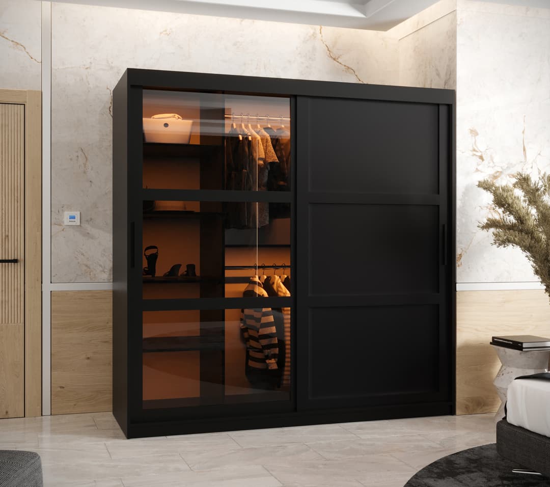 The sliding door wardrobe in a bedroom setting with clothes inside