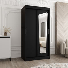 The black sliding door wardrobe with a mirrored door, shown in a bedroom setting