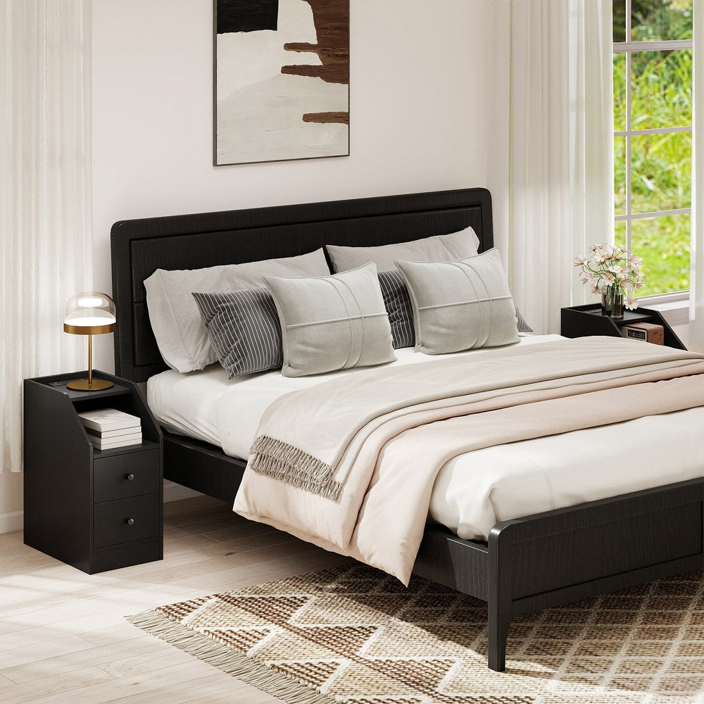 The end tables placed on both sides of a bed in a modern bedroom setting