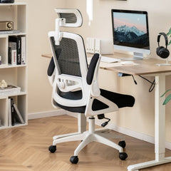 The office chair placed at a wooden desk with a computer monitor