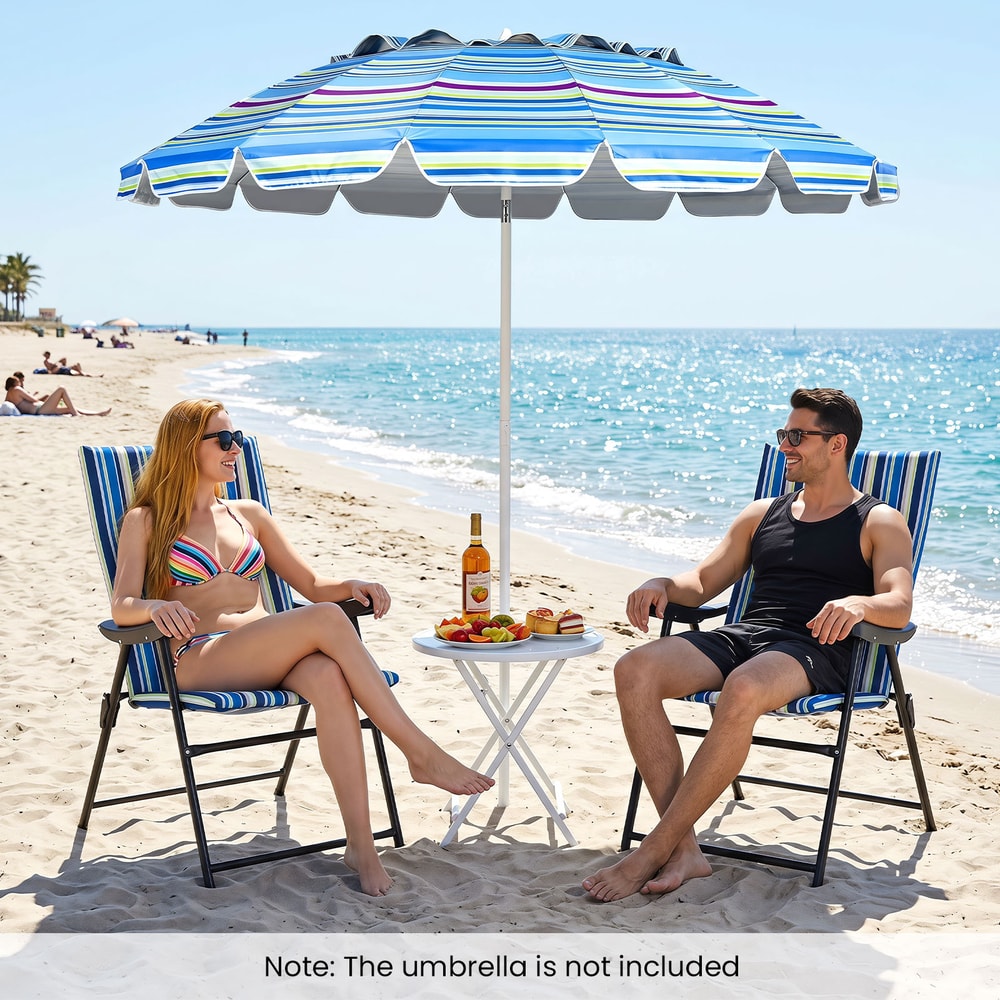 Two people relaxing on the beach in the blue striped chairs