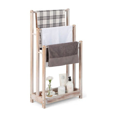 Freestanding Wood Towel Rack with three bars holding towels and toiletries on the bottom shelf
