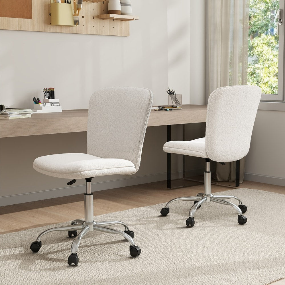Two white office chairs with wheels positioned at a desk in a home office setting