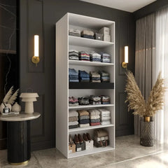 The hinged wardrobe interior with shelves full of folded clothes and shoes