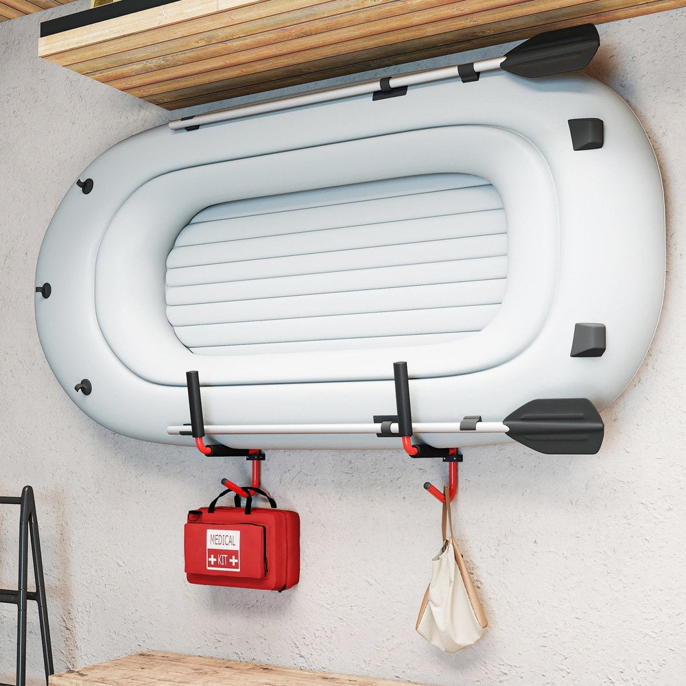 The inflatable kayak storage rack holding a white inflatable boat with paddles and a red medical kit