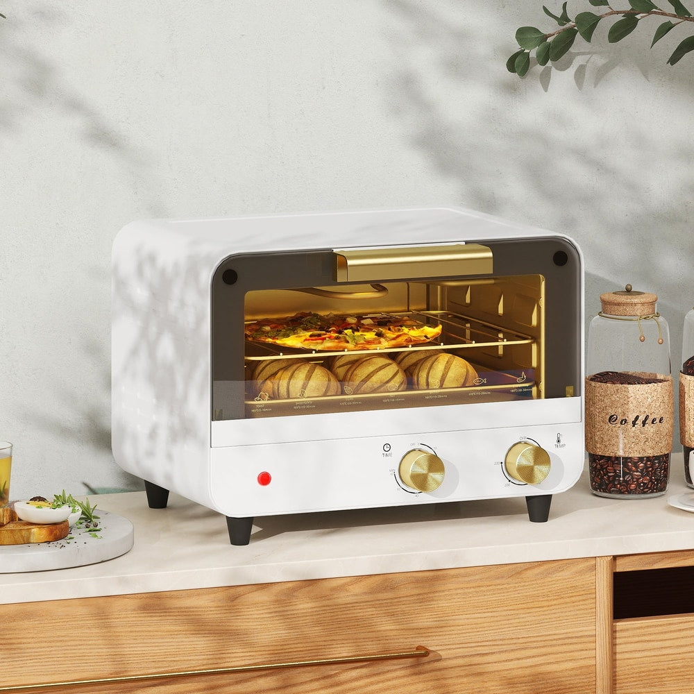 The small kitchen appliance is shown on a countertop with bread and coffee beans nearby