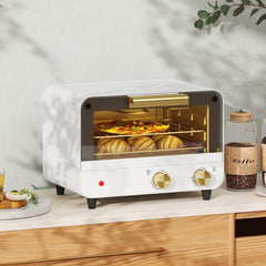 The small kitchen appliance is shown on a countertop with bread and coffee beans nearby