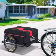 The bicycle cargo trailer attached to the back of a bicycle on a street